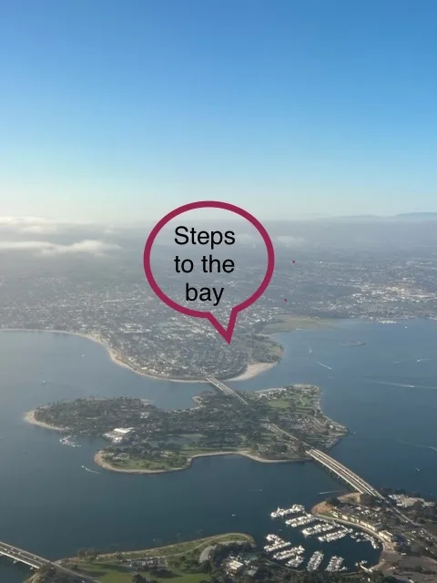 Aerial view over Mission Bay and Crown Point showing how close the house sits to the water